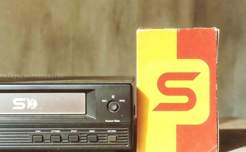 Vintage VCR player and classic VHS cassette tape representing the 1990s home video era of Malayalam cinema