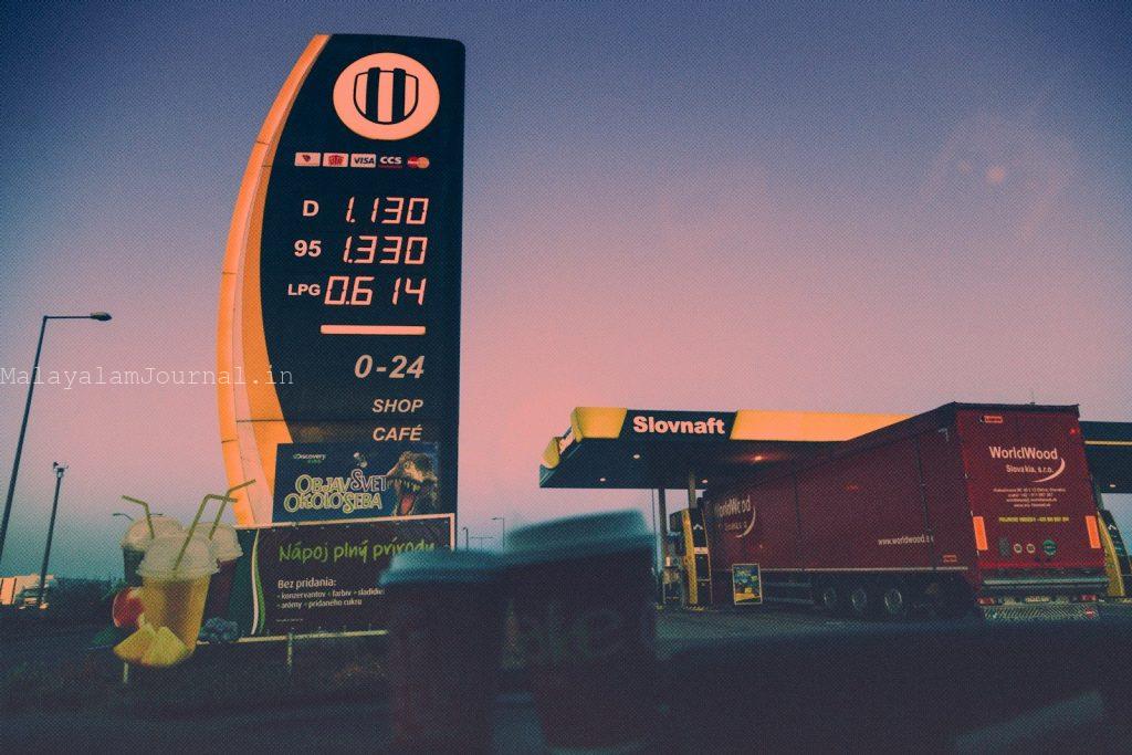 a gas station with a large sign next to it