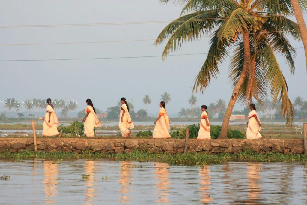 A group of women walking across a river