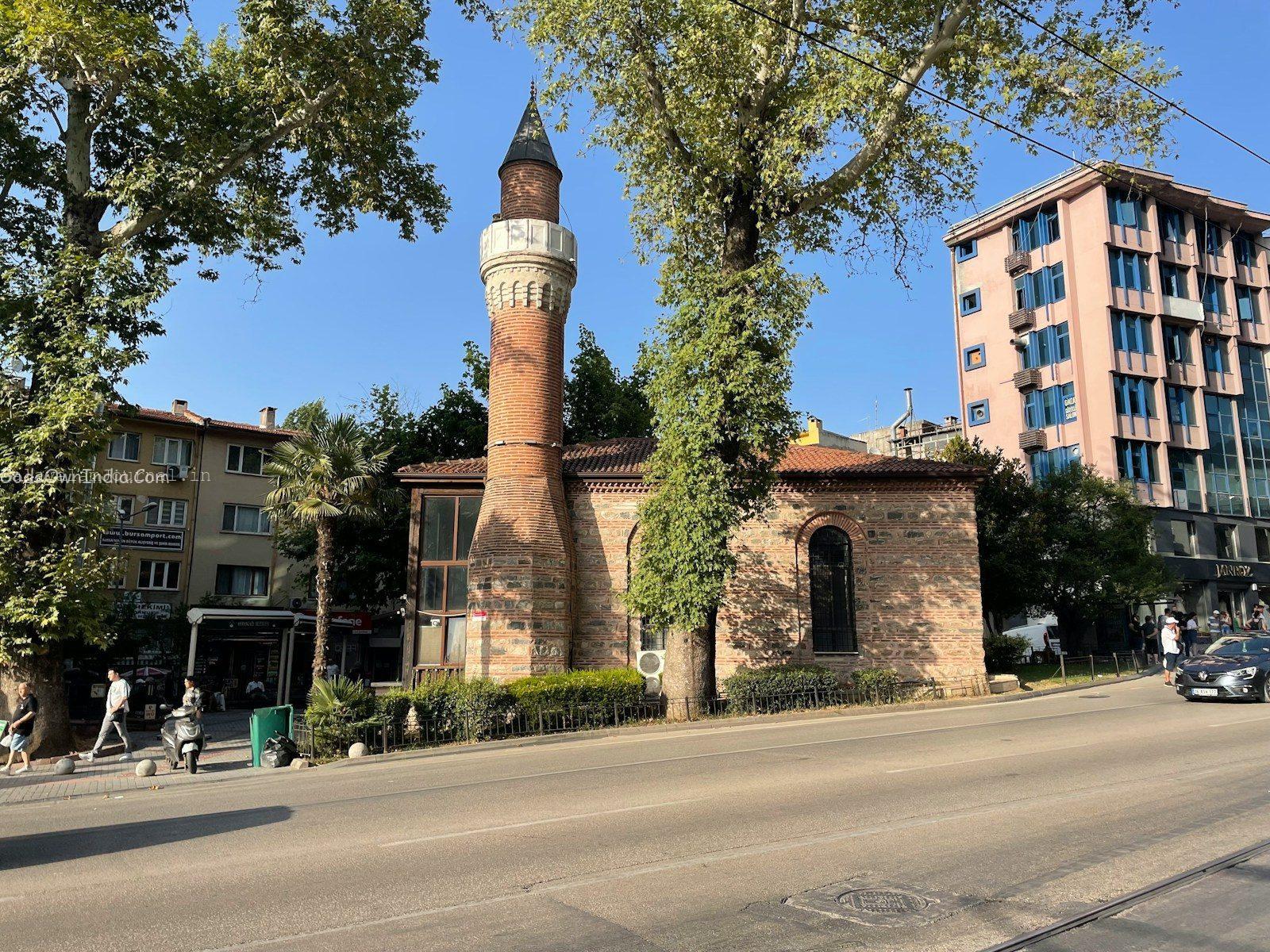 a tall brick building sitting on the side of a road